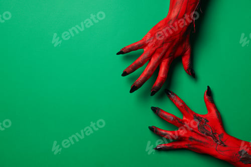 Preview: Creepy, red hands of a monster with black nails