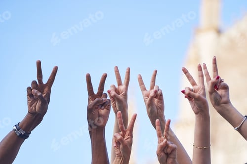 Preview: Group of multiracial people making peace or victory sign with hands.