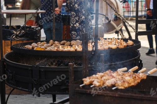 Preview: Delicious bbq potato and mushrooms roasting on open grill