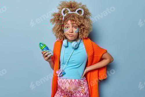 Preview: Upset pregnant woman with big tummy suffers from backache holds feeding bottle with milk awaits for