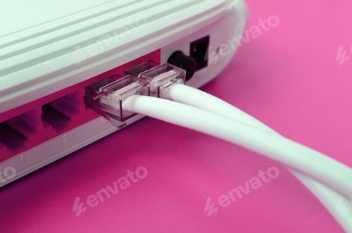 Preview: The Internet cable plugs are connected to the Internet router, which lies on a bright pink backgrou