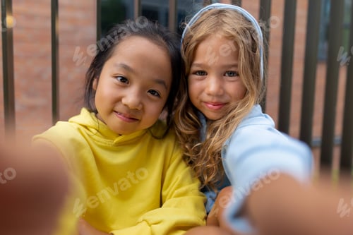 Preview: Happy children, friends, taking selfie in the city.