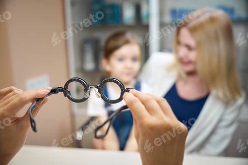 Preview: Mom and little daughter are sitting at table at doctors appointment