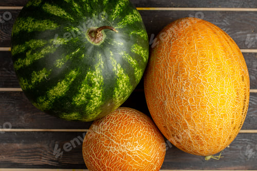 Preview: top close view green watermelon whole round formed fresh and juicy fruit with melons on the brown