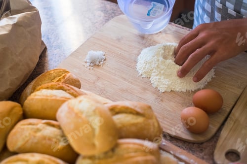 Preview: closeup in the kitchen with caucasian woman hand working and preparing cake or bakery