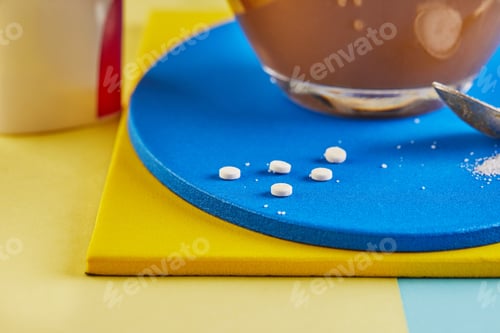 Preview: A cup of coffee and Pills of sugar substitute and natural sweetener in powder