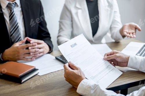Preview: Employer or recruiter holding reading a resume with talking during about his profile of candidate