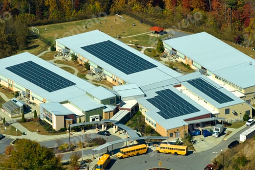 Preview: Aerial view of american school building with rooftop covered with photovoltaic solar panels