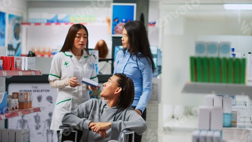 Preview: Asian client and social worker asking specialist about vitamins