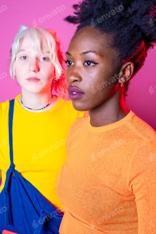 Preview: Two young diverse multicultural caucasian and black women best friends posing isolated background