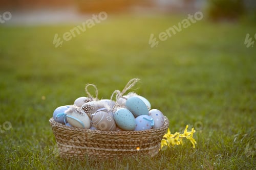Preview: Easter eggs in basket in grass. Traditional egg hunt for spring holidays