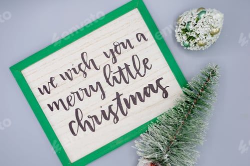 Preview: Minimal Christmas flat lay with a sign that says we wish you a merry little Christmas
