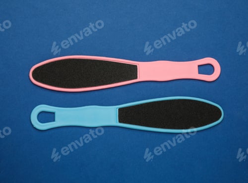 Preview: Colorful foot files on blue background, flat lay. Pedicure tools