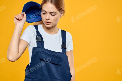 Preview: Woman in working uniform blue cap delivering courier service yellow background