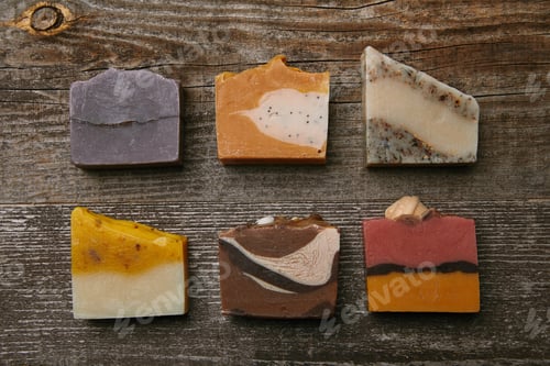Preview: top view of different handmade soap pieces on rustic wooden tabletop
