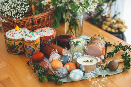 Preview: Easter modern eggs, cake, ham, beets, butter in rustic basket decorated with green buxus branches