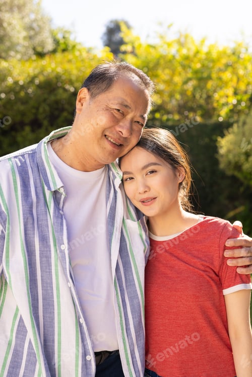 Preview: Embracing outdoors, smiling asian father and daughter enjoying quality family time together
