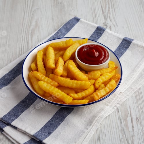 Preview: Homemade Unhealthy Crinkle French Fries with Ketchup on a Plate, side view.