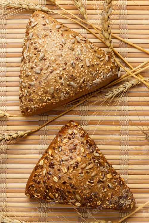 Preview: Rustic bread and wheat on an old vintage planked wood table. free text space