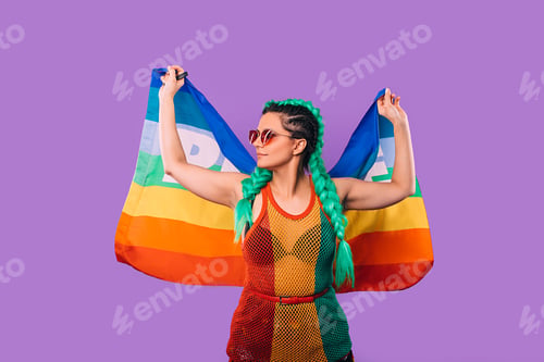 Preview: Rainbow flag in the hands of a hipster woman in rasta dress. World peace. On a purple background