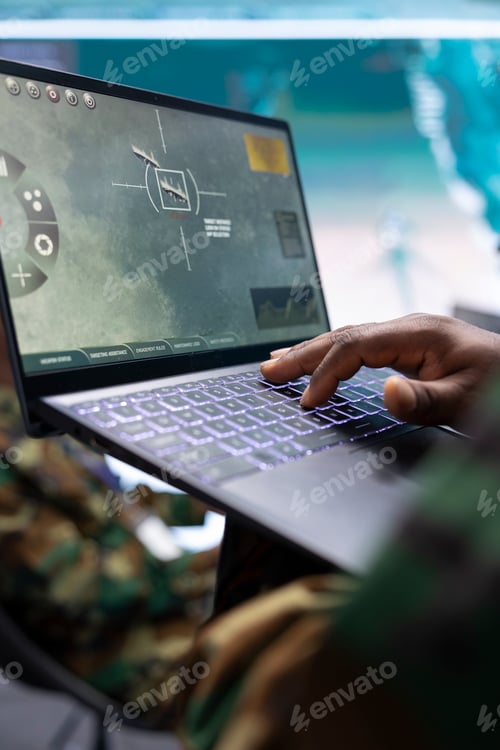 Preview: Military expert in a control center uses advanced technology on laptop