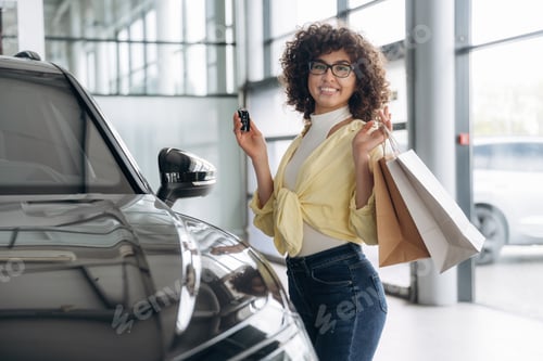 Preview: Right after the shopping, with bags and keys. Pretty woman is in the car retail shop