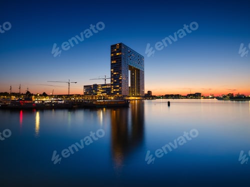 Preview: Amsterdam, Netherlands. A cityscape in the evening. A skyscraper and business center