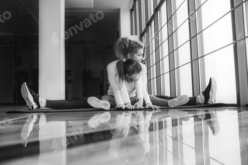 Preview: Mother and daughter makeing yoga in the gym