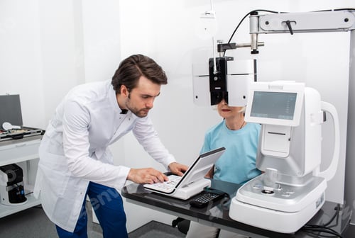 Preview: Experienced optometrist doing site testing for a patient using a modern phoropter at a medical