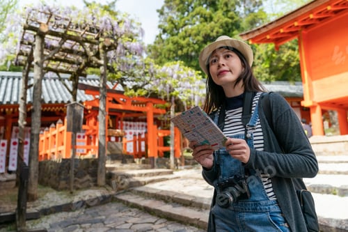 Preview: happy woman using route map at Kasuga shrine