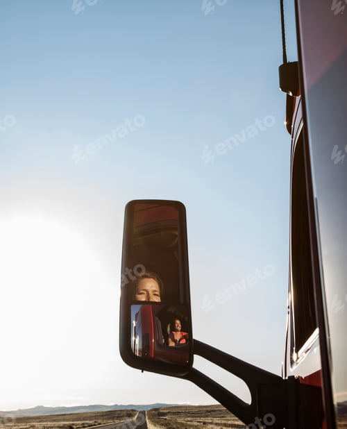 Preview: View of a Caucasian woman driver in the cab of her commercial truck.