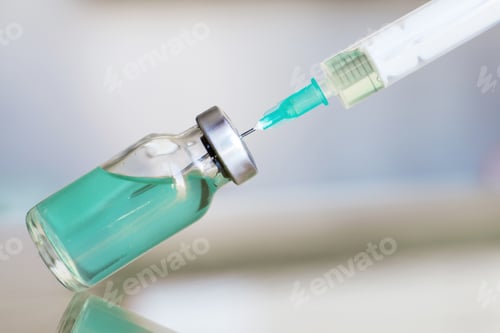 Preview: Vial filled with liquid vaccine in medical lab with syringe. medical ampoule and syringe