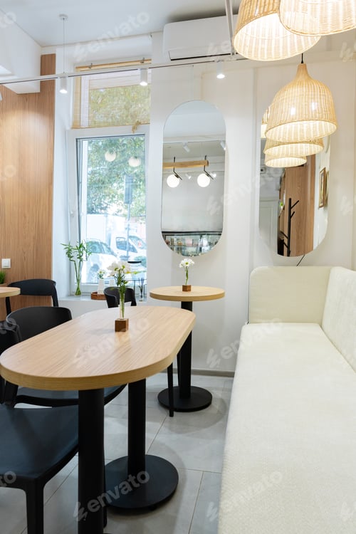 Preview: Cozy cafe interior with soft lighting and modern furniture in the afternoon