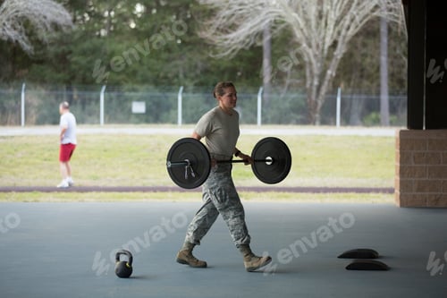 Preview: Female soldier carrying barbell at military air force base