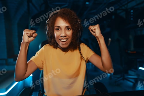 Preview: Young curly woman playing cyber games.