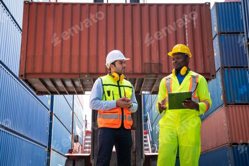Preview: Container yard manager with safety hat talking to foreman.