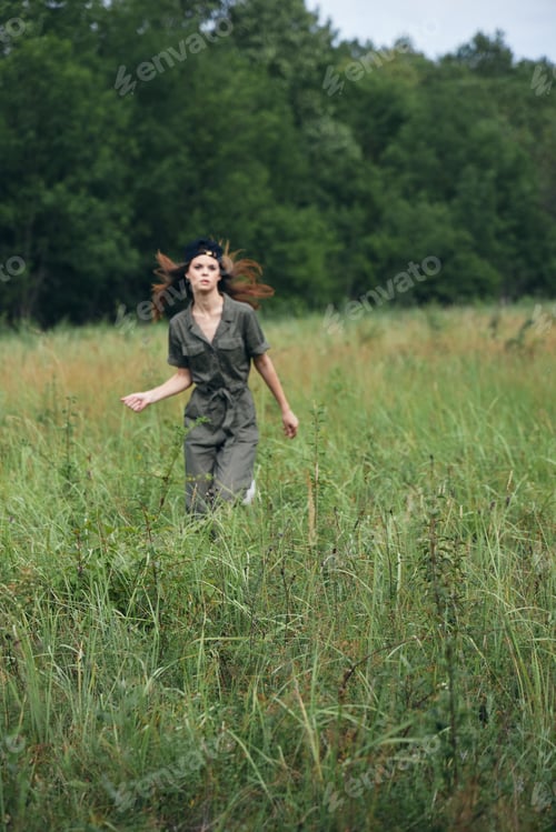 Preview: Woman in the meadow Tickets in green jumpsuit fresh air outdoor activities