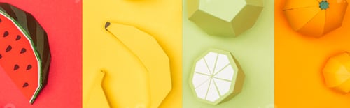 Preview: panoramic shot of origami watermelon, bananas, tangerines and limes on colorful striped paper