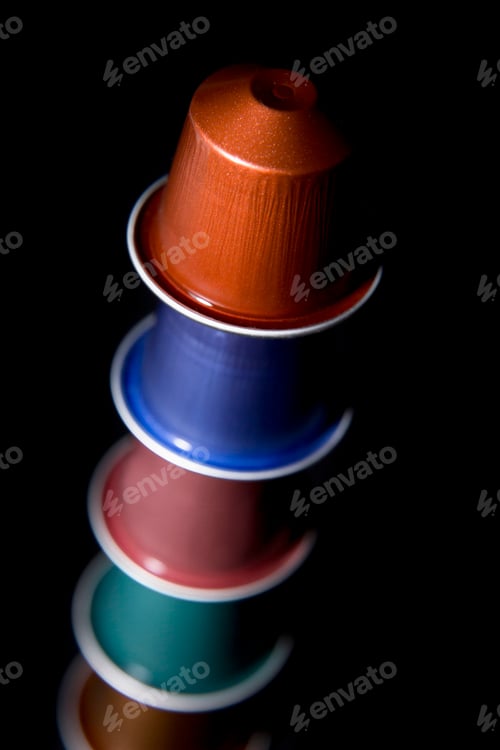Preview: close up of a group of colored coffee capsules arranged on top of each other
