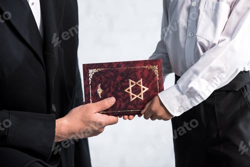 Preview: cropped view of jewish father and cute son holding tanakh