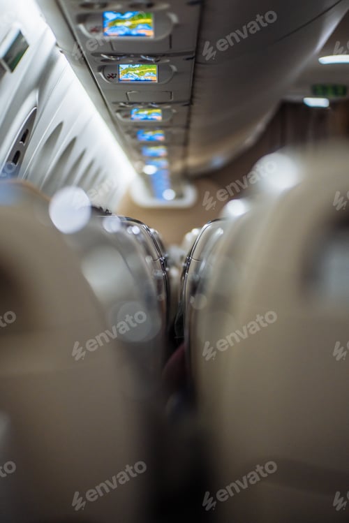 Preview: A vertical photo of the plane's interior between the rows of seats.