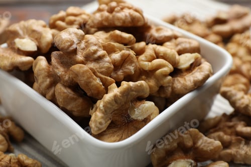 Preview: Peeled walnuts in bowl on table, closeup