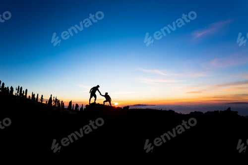 Preview: Teamwork couple climbing helping hand