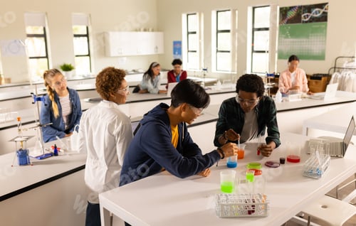 Preview: In high school, teenagers conducting science experiments in classroom laboratory setting