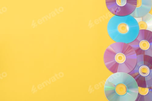 Preview: Colorful cds on a yellow vibrant background