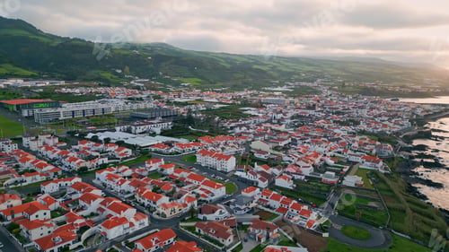 Preview: Aerial seaside buildings view in stormy morning. Calm cape village wash by sea