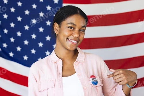 Preview: Young biracial woman poses proudly with her vote badge in front of an American flag, promoting civic
