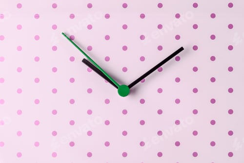 Preview: Clock hands on pink polka dot gift wrapping paper.