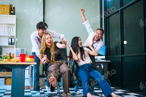 Preview: Four Asian friends, two men and two women, celebrate in an office party. They enjoy a fun-filled