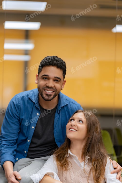 Preview: Coworkers sharing a moment in an office lounge.